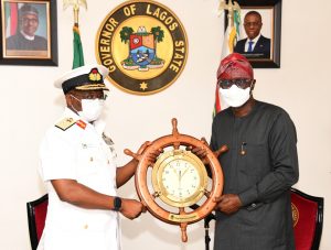Chief of Naval Staff (CNS), Vice Admiral Awwal Gambo presents a souvenir to Lagos State Governor, Babajide Sanwo-Olu during his courtesy visit to the governor, at Lagos House, Marina, on Tuesday.